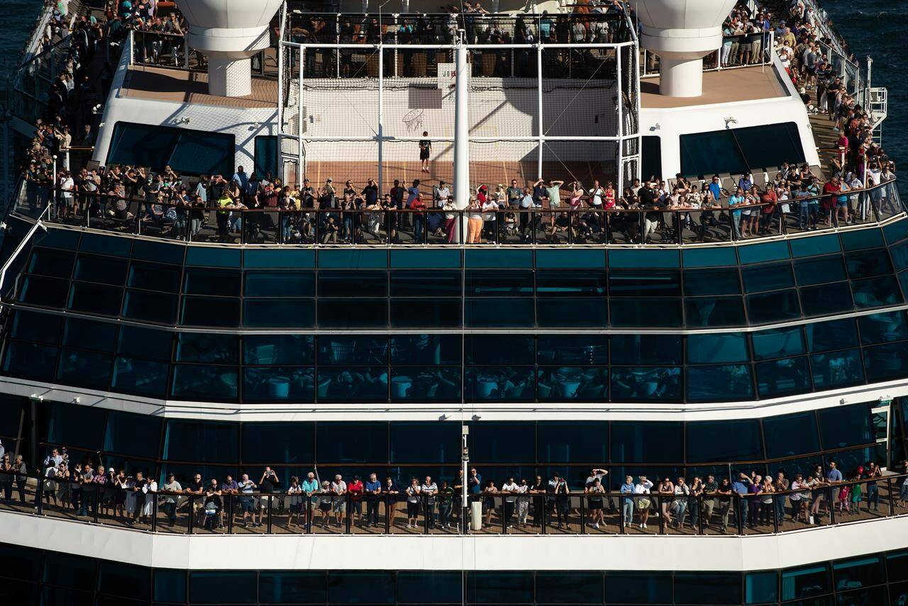 People stand on decks at the bow of the Celebrity Cruises vessel Celebrity Eclipse as it leaves port in Vancouver for a trip to Alaska, on Sunday, Aug. 14, 2022. THE CANADIAN PRESS/Darryl Dyck