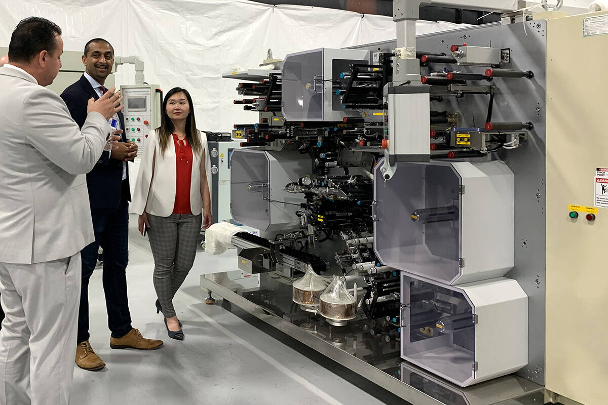 Mitchell Miller, CEO of Atlas Power Technologies in Abbotsford, gives a tour of his facility to ministers Ravi Kahlon and Anne Kang on Aug. 24. (Jessica Peters/Abbotsford News)