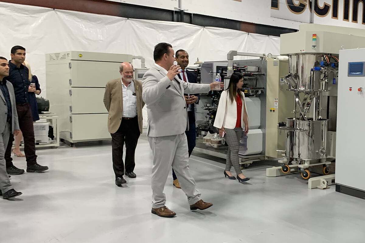 Mitchell Miller, CEO of Atlas Power Technologies in Abbotsford, gives a tour of his facility to ministers Ravi Kahlon and Anne Kang on Aug. 24. (Jessica Peters/Abbotsford News)