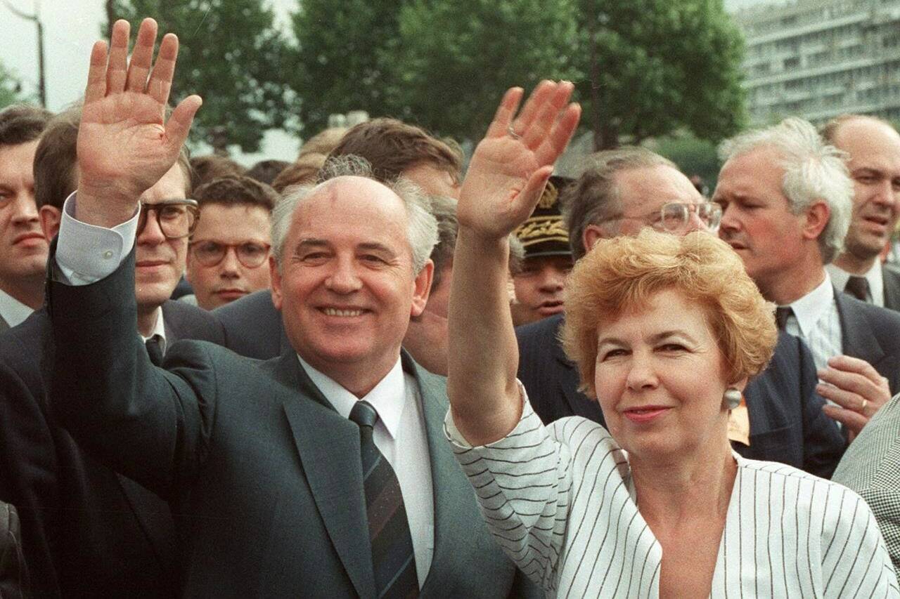 FILE - Soviet President Mikhail Gorbachev and his wife Raisa wave to a crowd during their visit in Paris, France, Wednesday, July 5, 1989. Russian news agencies are reporting that former Soviet President Mikhail Gorbachev has died at 91. The Tass, RIA Novosti and Interfax news agencies cited the Central Clinical Hospital. (AP Photo/Laurent Rebours, File)