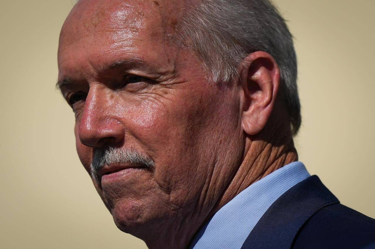 B.C. Premier John Horgan pauses while speaking during a funding announcement for a planned middle-secondary school, in Coquitlam, B.C., on Tuesday, August 30, 2022. THE CANADIAN PRESS/Darryl Dyck