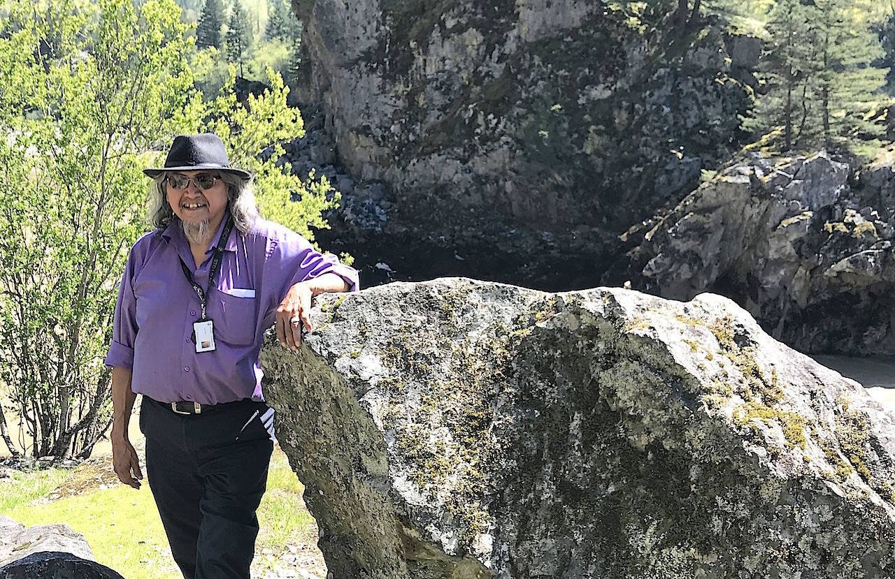 Sonny McHalsie, a Stó:lō historian, with Bad Rock (Xéylxelamós) behind him, a sacred transformation site on the Fraser River, also known as Lady Franklin Rock, near Yale. Recently 45 sacred sites of the Stó:lō have gained legal protection. (Jennifer Feinberg/ Chilliwack Progress file)