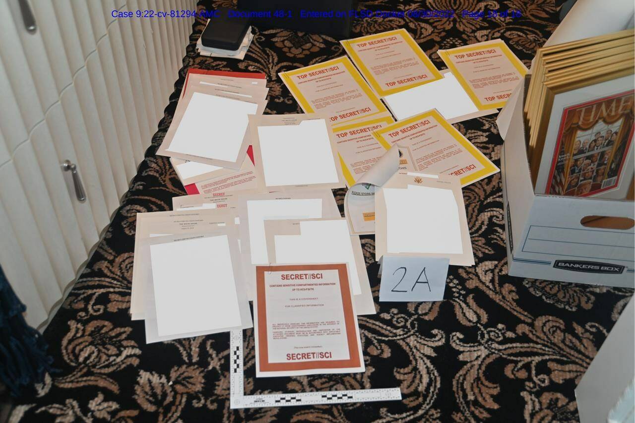 This image contained in a court filing by the Department of Justice on Aug. 30, 2022, and redacted by in part by the FBI, shows a photo of documents seized during the Aug. 8 search by the FBI of former President Donald Trump’s Mar-a-Lago estate in Florida. The Justice Department says it has uncovered efforts to obstruct its investigation into the discovery of classified records at former President Donald Trump’s Florida estate. (Department of Justice via AP)