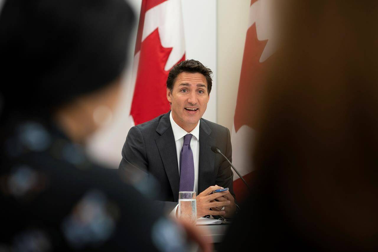 Prime Minister Justin Trudeau addresses participants at the beginning of a housing round table at the Country Hills Library in Kitchener, Ont., on Aug. 30, 2022. THE CANADIAN PRESS/Peter Power-POOL