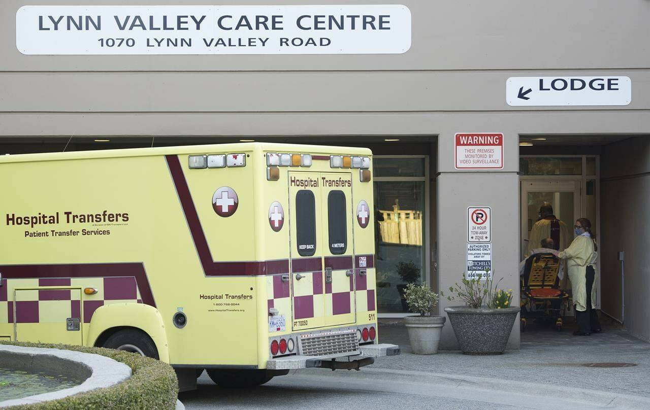 Hospital transfer workers are seen outside the Lynn Valley Centre care home in North Vancouver, B.C., on Wednesday, April 8, 2020. The union representing the majority of 60,000 hospital and long-term care workers in British Columbia says a tentative agreement has been reached with the Hospital Employers Association of B.C. after 65 days of contract negotiations. THE CANADIAN PRESS/Jonathan Hayward