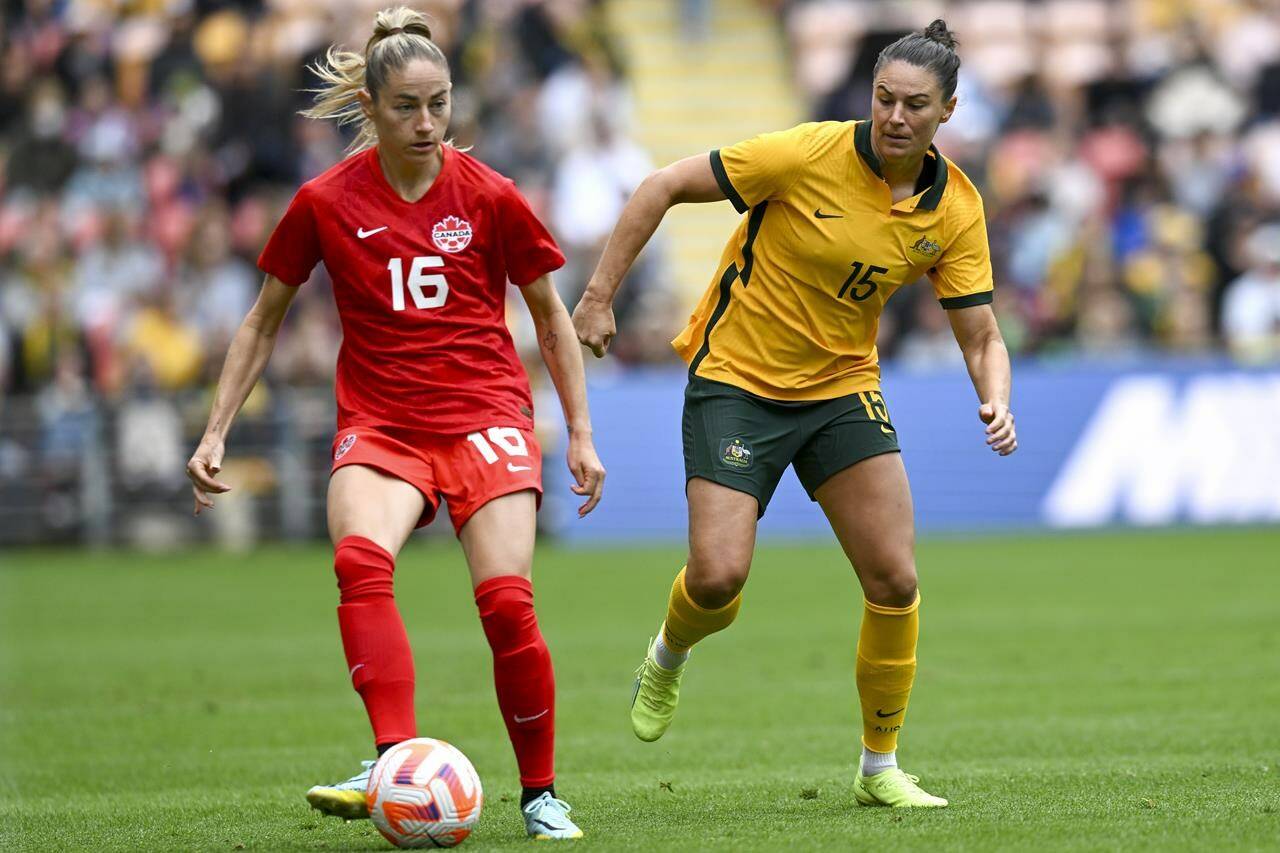 Janine Beckie, left, of Canada battles fort the ball with Emily Gielnik of Australia during the women’s soccer friendly between Australia and Canada at Suncorp Stadium in Brisbane, Australia, Saturday, Sept. 3, 2022. (Darren England/AAP Image via AP)