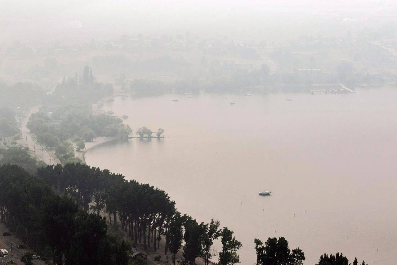 Thick smoke from the B.C. wildfires blankets Okanagan Lake in Vernon, B.C., on Monday, Aug. 20, 2018. THE CANADIAN PRESS/Jeff Bassett