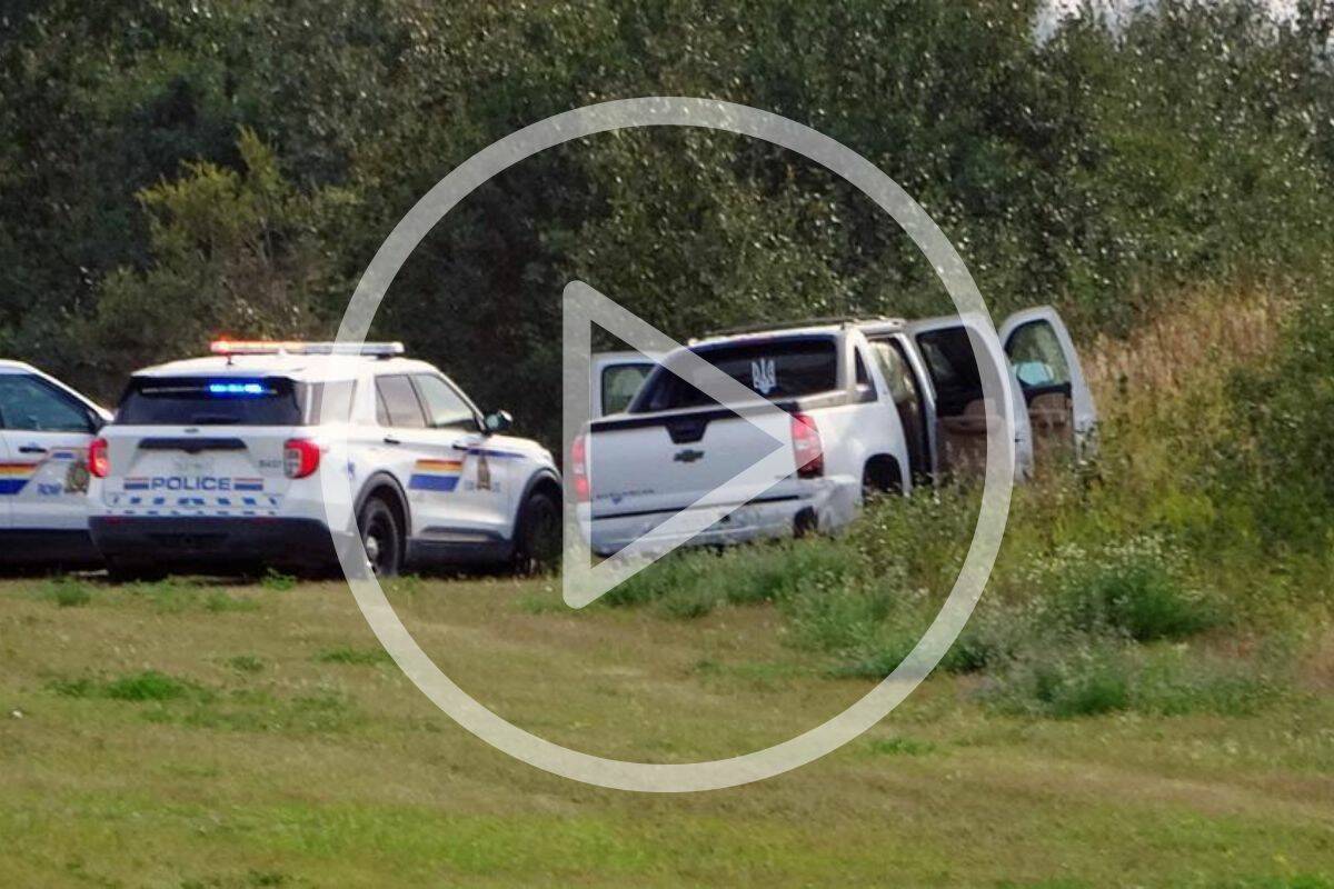 Police and investigators are seen at the side of the road outside Rosthern, Sask., on Wednesday, Sept. 7, 2022. The chief of a Saskatchewan First Nation is to speak the day after the suspect in a deadly stabbing rampage died after being taken into police custody. Myles Sanderson went into medical distress shortly after being arrested Wednesday, bringing an end to a four-day manhunt. THE CANADIAN PRESS/Heywood Yu