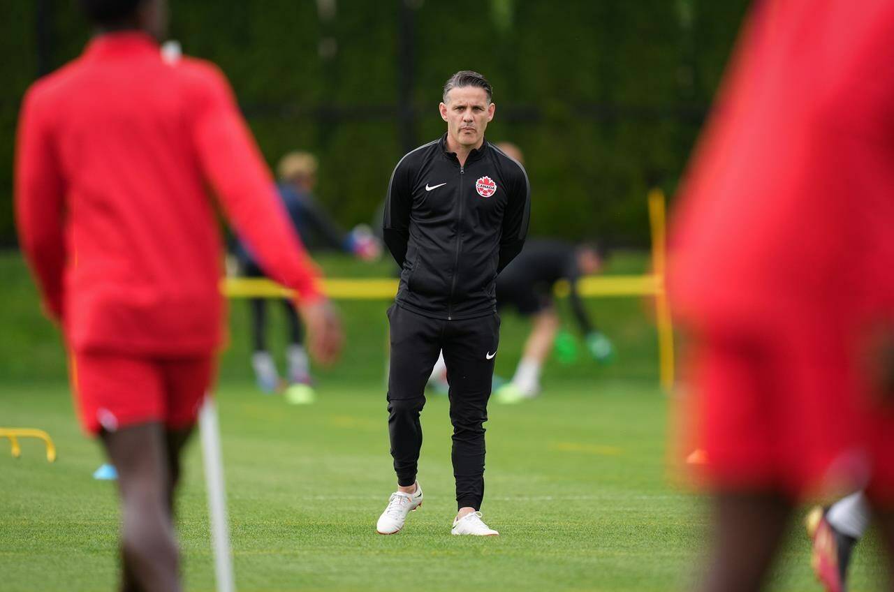 Canadian national men’s soccer team head coach John Herdman watches a training session for a CONCACAF Nations League match against Curacao, in Vancouver, on Tuesday, June 7, 2022. Canada will play Japan on Nov. 17 in Dubai in its final warmup game before the World Cup in Qatar. THE CANADIAN PRESS/Darryl Dyck
