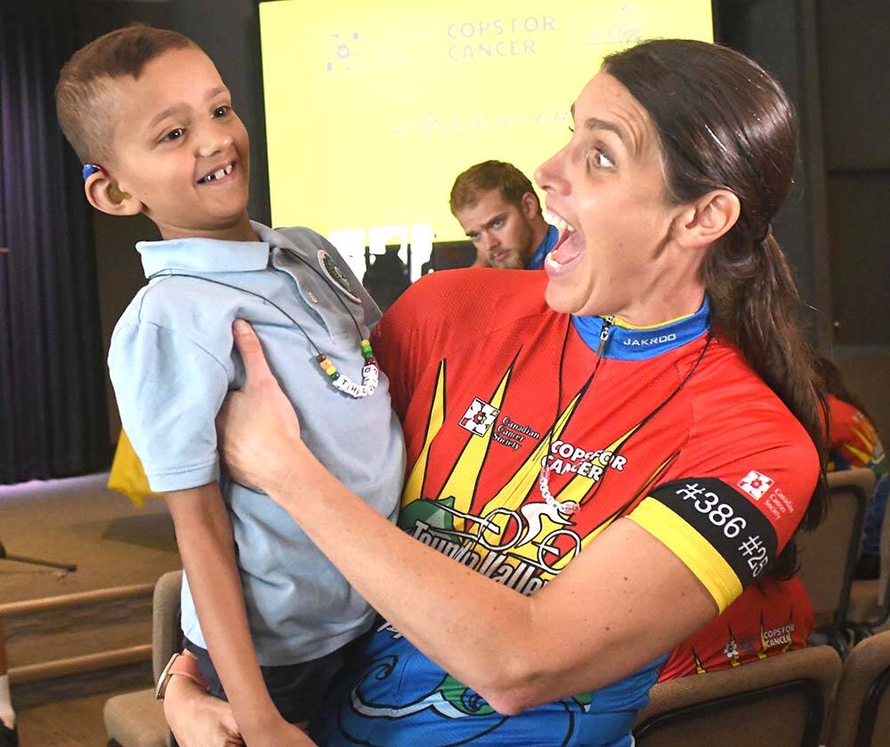 Upper Fraser Valley RCMP Sgt. Krista Vrolyk and Thar hang out in Abbotsford on Wednesday (Sept. 7) during the jersey presentation for participants in the Cops for Cancer Tour de Valley. (John Morrow/Abbotsford News).