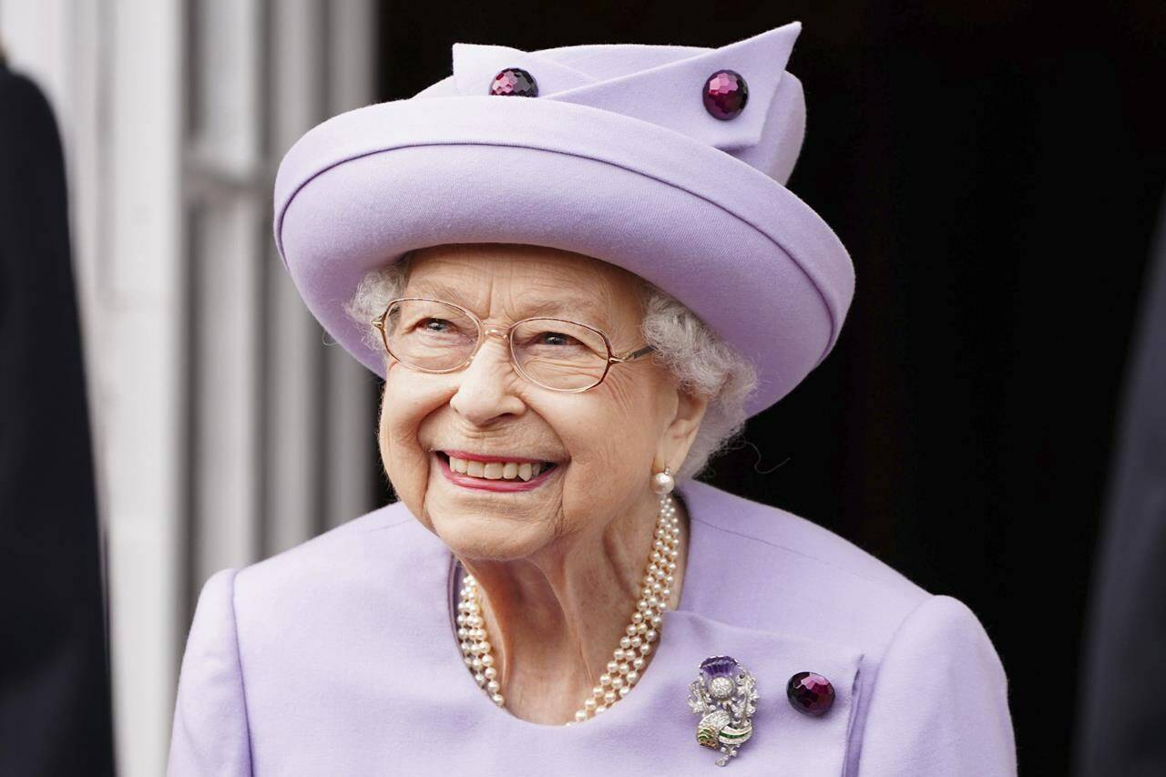 Queen Elizabeth II attends an armed forces act of loyalty parade in the gardens of the Palace of Holyroodhouse, Edinburgh, Tuesday, June 28, 2022. THE CANADIAN PRESS/Jane Barlow/Pool via AP