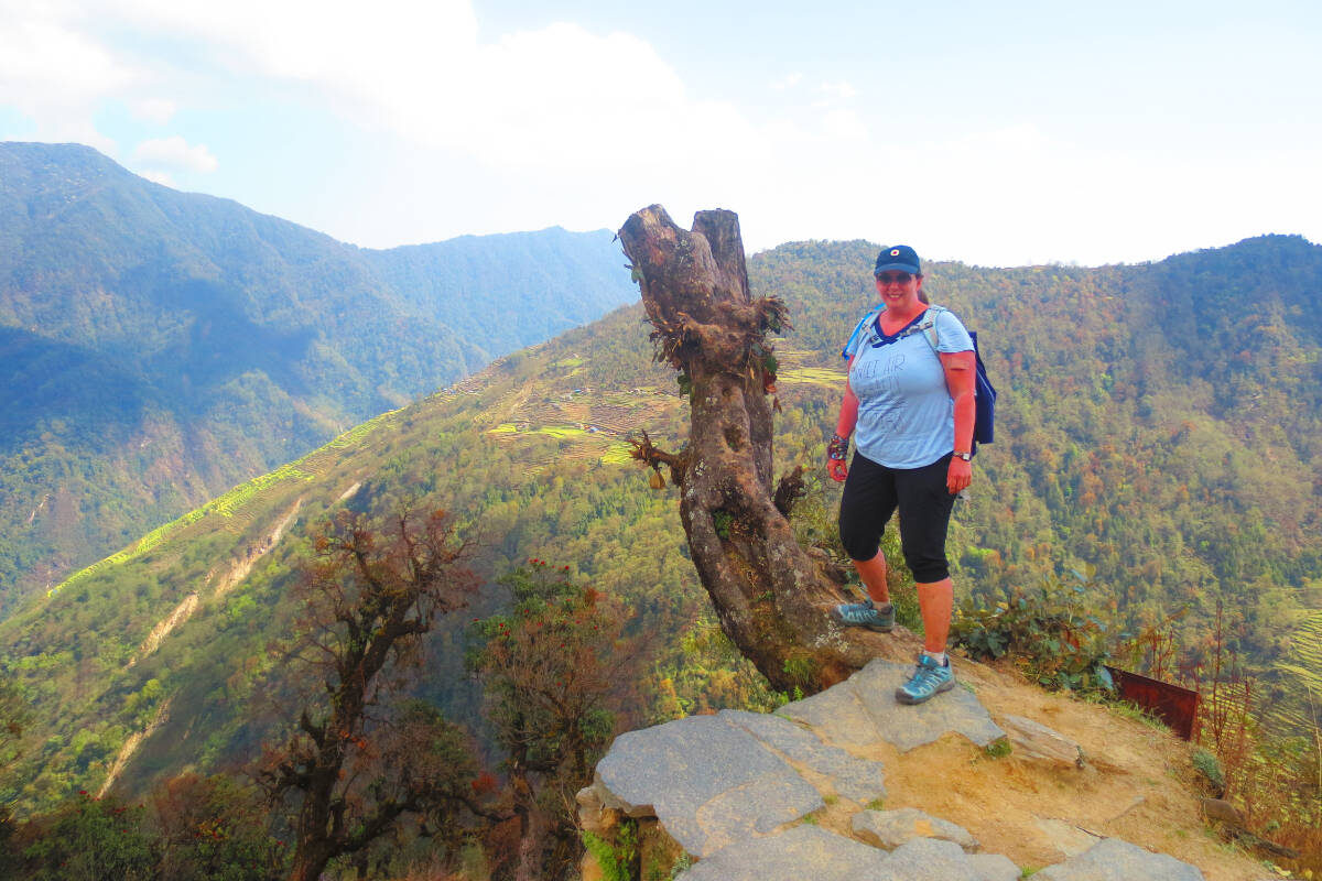 Angela Wright stands at a viewpoint along a trek she completed outside of Ghorepani, Nepal, despite being told she would never walk again. (Photo submitted)