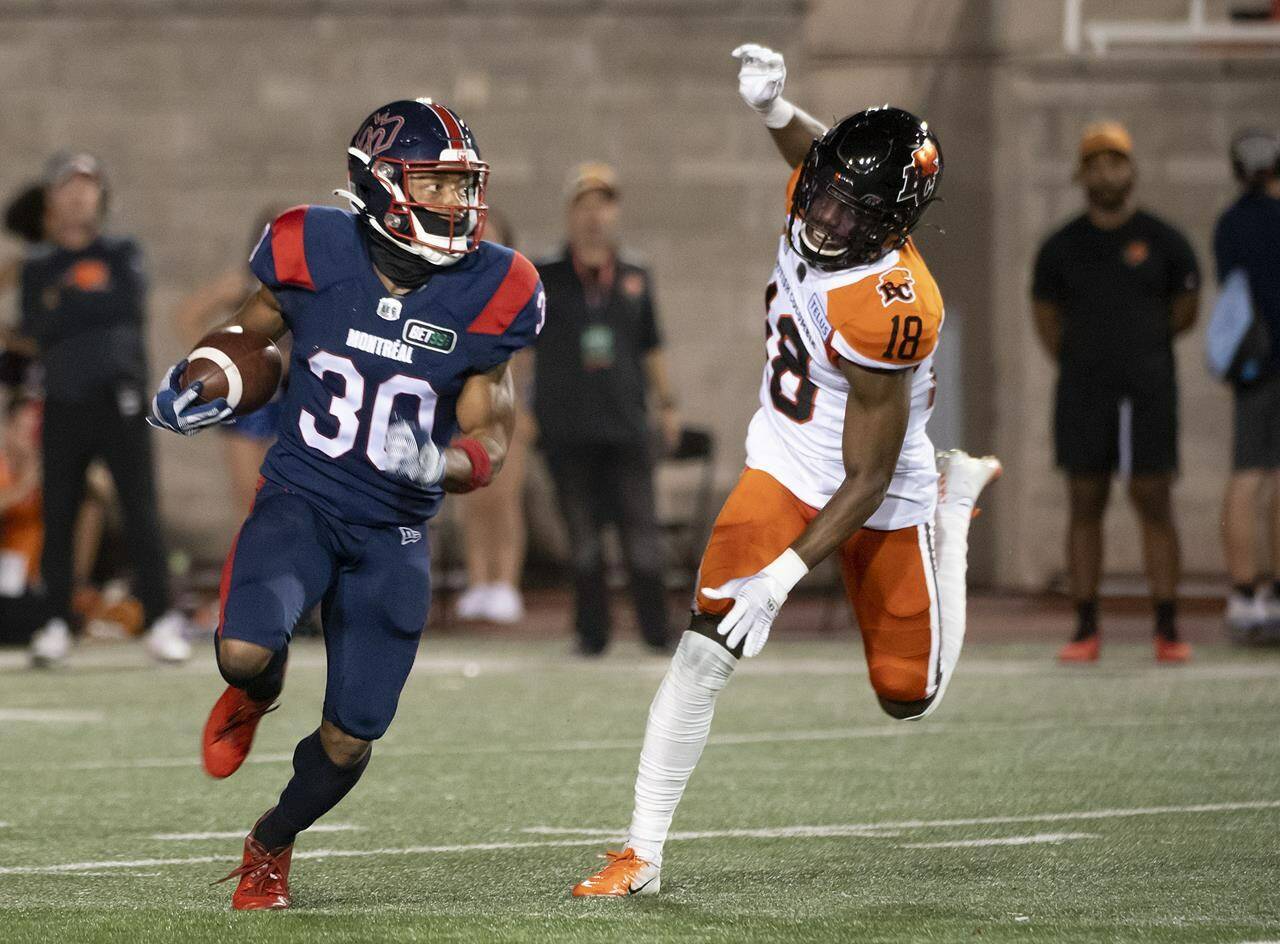B.C. Lions’ Hakeem Johnson (18) runs after Montreal Alouettes’ Chandler Worthy (30) during first half CFL football action in Montreal on Friday, September 9, 2022. THE CANADIAN PRESS/Peter McCabe