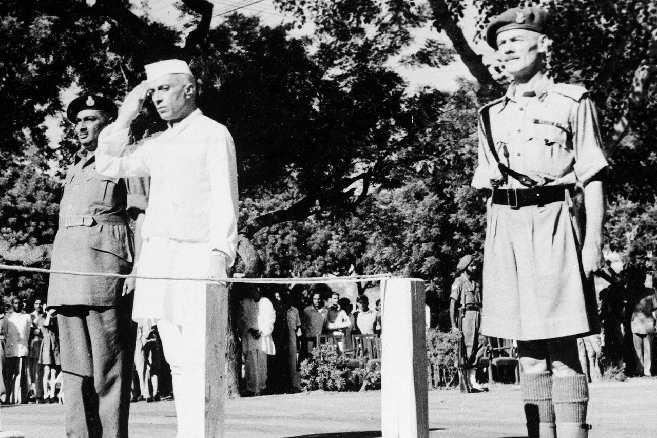 Jawaharlal Nehru salutes the flag as he becomes independent India’s first prime minister on Aug. 15, 1947, during the Independence Day ceremony at Red Fort, New Delhi, India. “At the stroke of the midnight hour, when the world sleeps, India will awake to life and freedom,” Nehru famously spoke, words that were heard over live radio by millions of Indians. Then he promised: “To the nations and peoples of the world, we send greetings and pledge ourselves to cooperate with them in furthering peace, freedom and democracy.” (AP Photo/File)