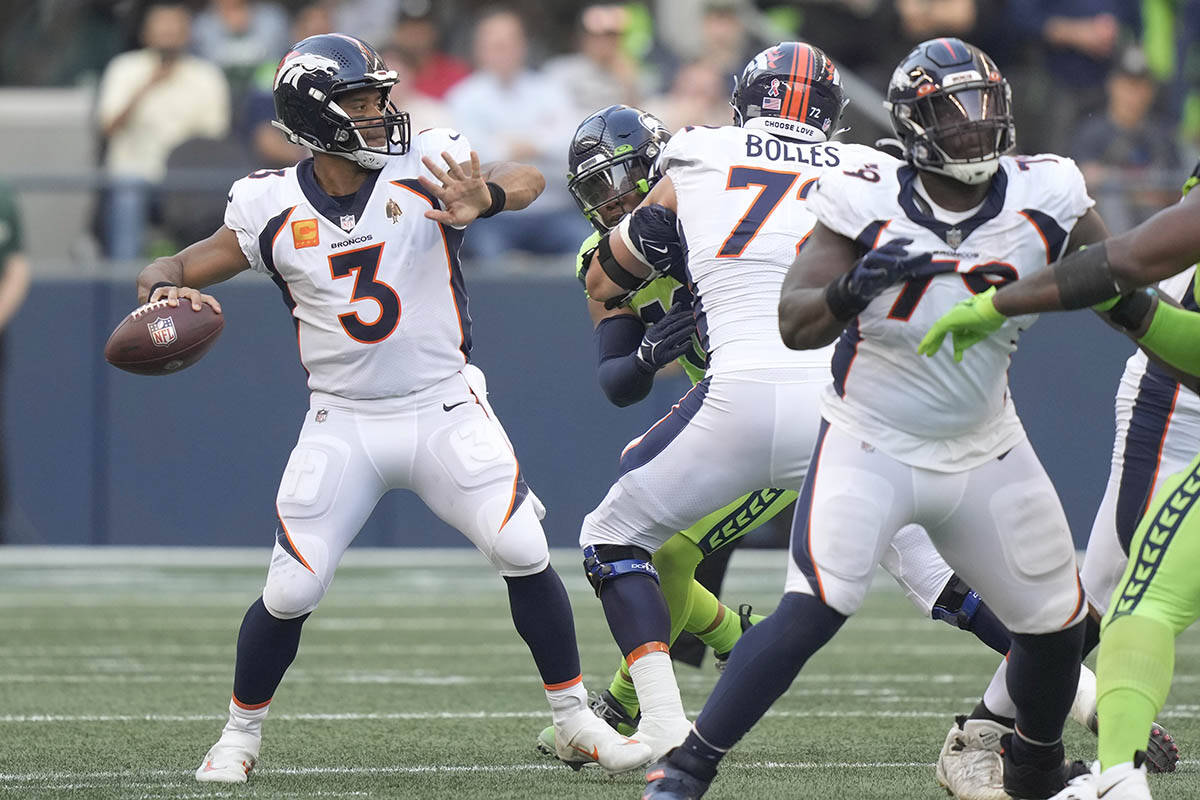 Denver Broncos quarterback Russell Wilson (3) passes for a touchdown against the Seattle Seahawks during the first half of an NFL football game, Monday, Sept. 12, 2022, in Seattle. (AP Photo/Stephen Brashear)