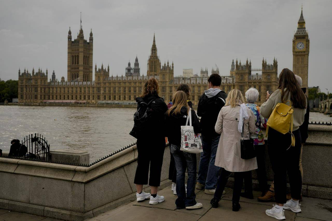 Tourists stand outside of Westminster Place in London, Tuesday, Sept. 13, 2022. Queen Elizabeth II, Britain’s longest reigning monarch, will lay in state at Westminster Palace from Wednesday. THE CANADIAN PRESS/AP/Markus Schreiber