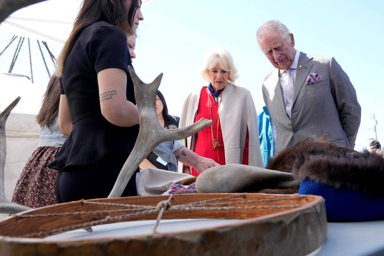 Prince Charles, right, and Camilla, Duchess of Cornwall, second from right, look at a display of traditional hunting tools and clothing after arriving in Yellowknife, Northwest Territories, during part of the Royal Tour of Canada, Thursday, May 19, 2022. Some Indigenous leaders and community members say they’re concerned about making progress on reconciliation with King Charles III. THE CANADIAN PRESS/Paul Chiasson