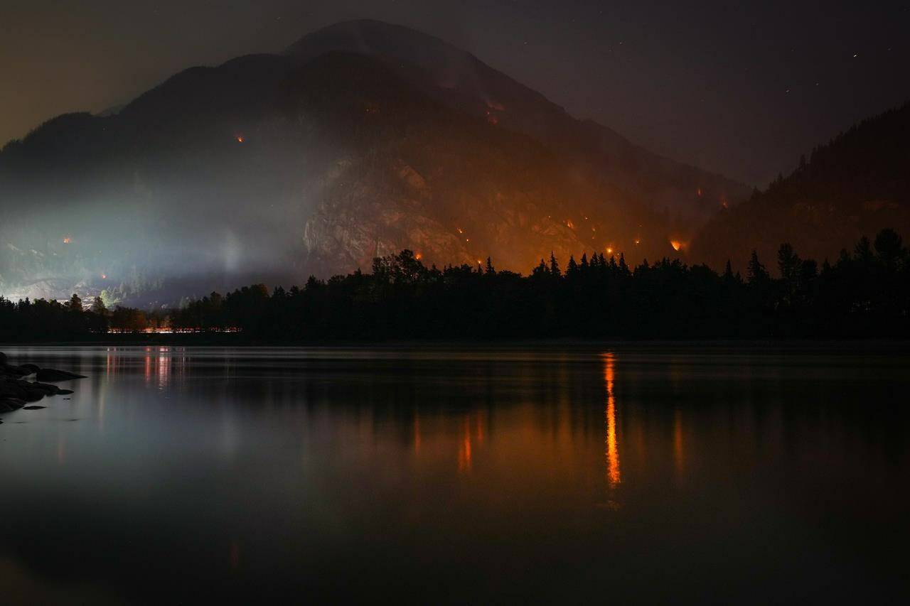 The Flood Falls Trail wildfire burns above the Fraser River in Hope, B.C., Monday, Sept. 12, 2022. THE CANADIAN PRESS/Darryl Dyck