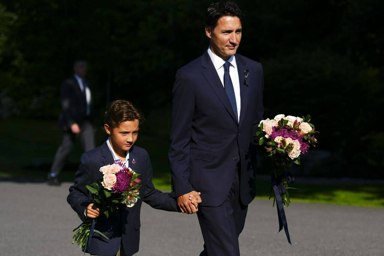 Prime Minister Justin Trudeau and son Hadrien arrive to place flowers for Queen Elizabeth II prior to a ceremony to proclaim the accession of the new Sovereign, King Charles III, at Rideau Hall, in Ottawa, Saturday, Sept. 10, 2022. Trudeau has declared Sept. 19 a federal holiday to mourn Queen Elizabeth II on the day of her state funeral in London. THE CANADIAN PRESS/Sean Kilpatrick