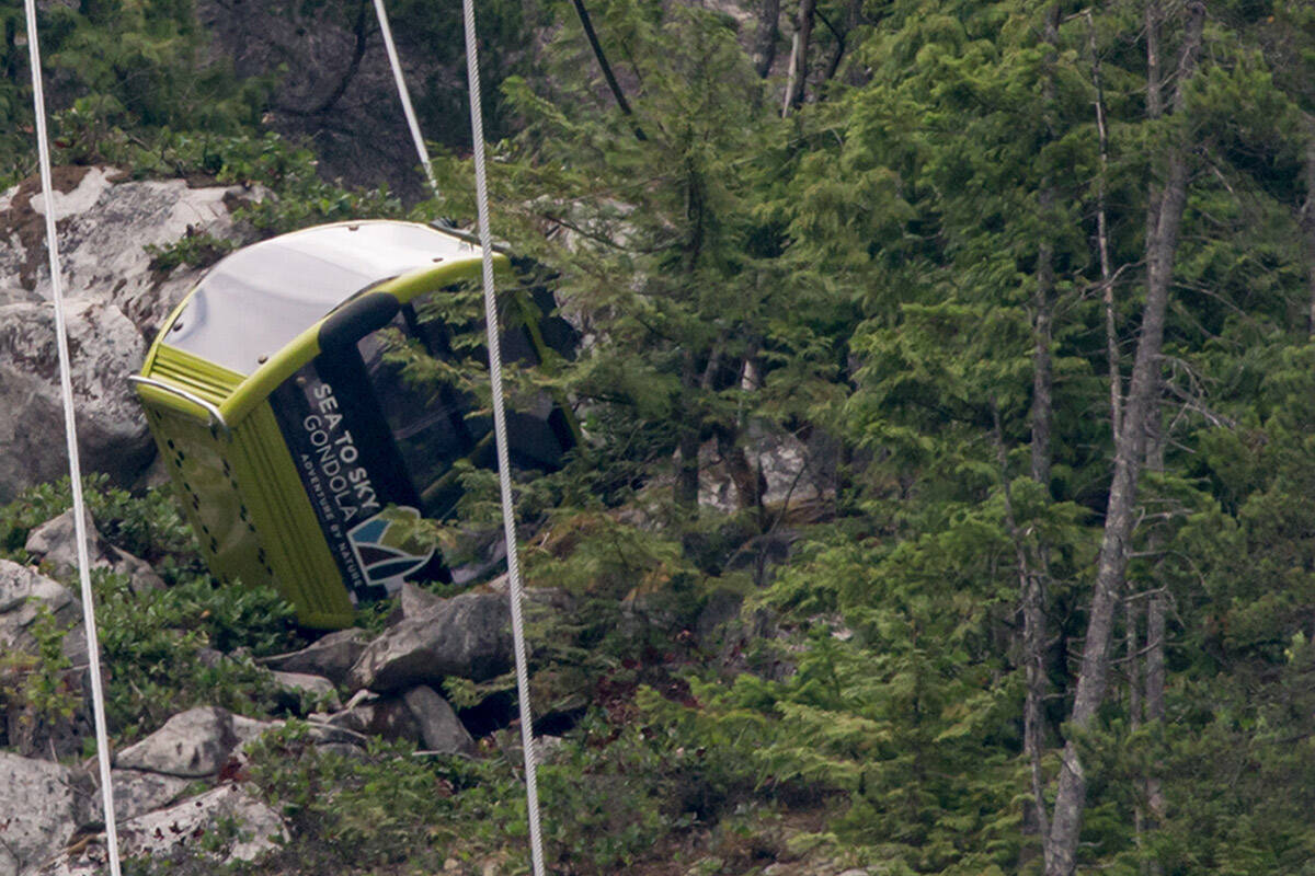 A gondola car rests on its side on the mountain after a cable snapped overnight at the Sea to Sky Gondola causing cable cars to crash to the ground below in Squamish, B.C., on Saturday, August 10, 2019. No injuries were reported and the gondola has been closed by operators for the foreseeable future. THE CANADIAN PRESS/Darryl Dyck
