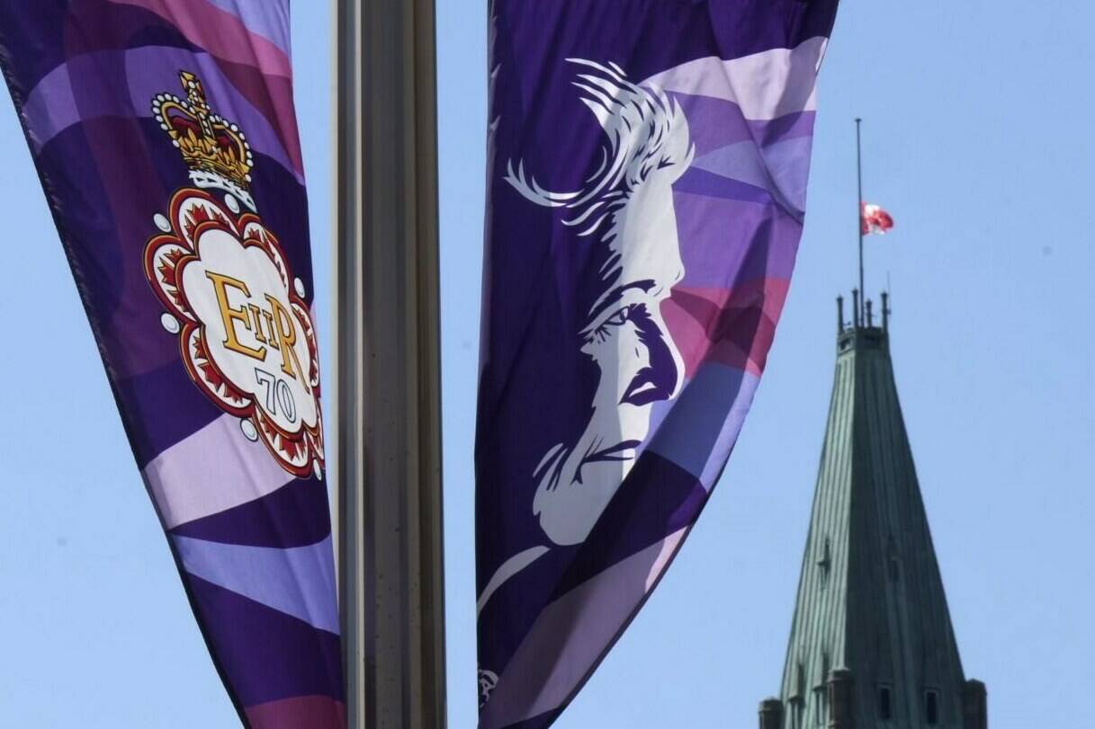The flag on the Peace Tower flies at half-mast behind banners of Queen Elizabeth celebrating the Platinum Jubilee, in Ottawa, Thursday, Sept.8, 2022. Members of Parliament of all political stripes are expected to rise in tribute to the late Queen Elizabeth today during a special sitting of the House of Commons. THE CANADIAN PRESS/Adrian Wyld