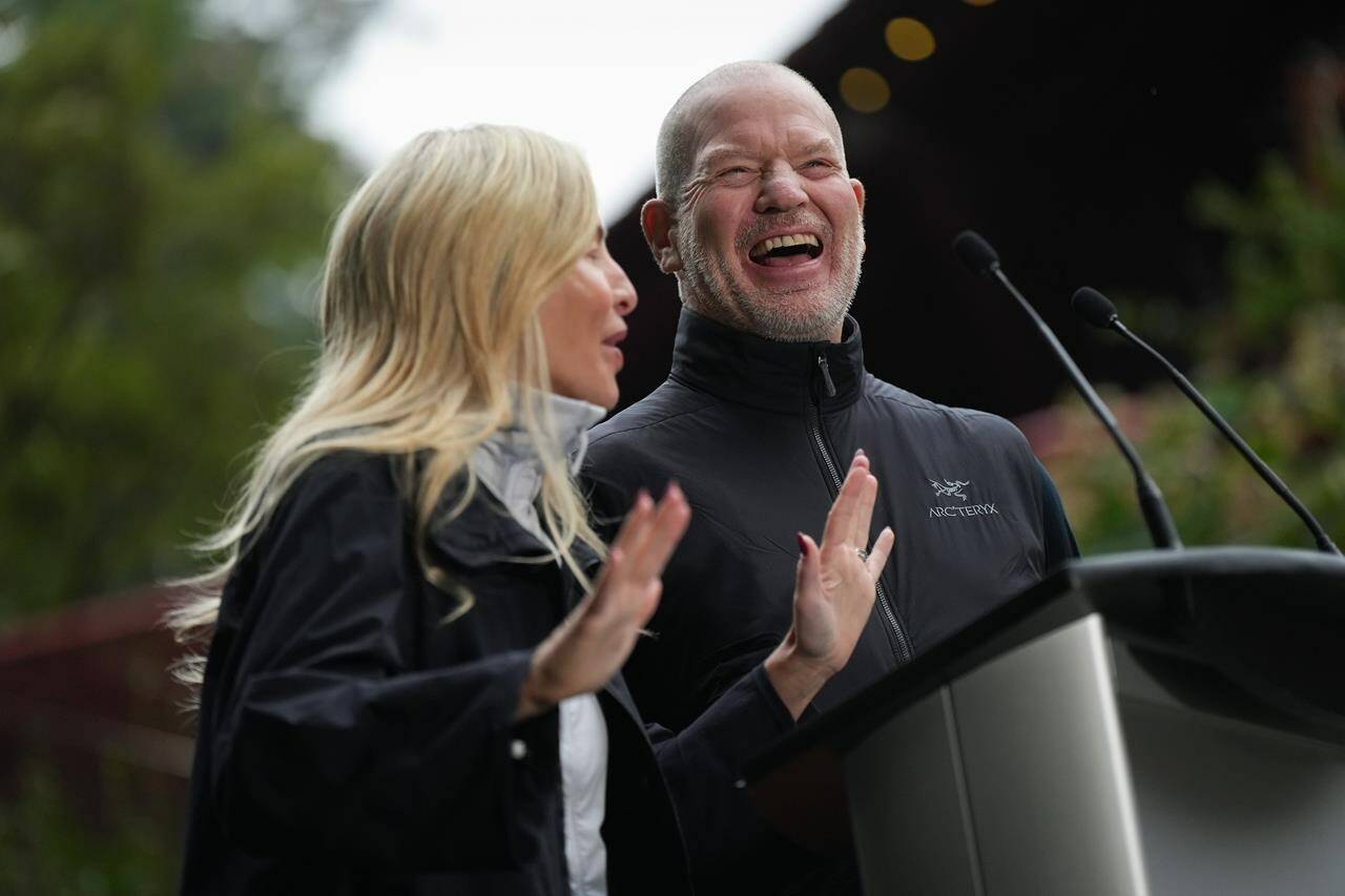 Lululemon founder Chip Wilson and his wife Summer Wilson laugh while speaking after announcing a $100 million donation to preserve and protect B.C.’s natural spaces through their Wilson 5 Foundation, in Vancouver, B.C., Thursday, Sept. 15, 2022. THE CANADIAN PRESS/Darryl Dyck