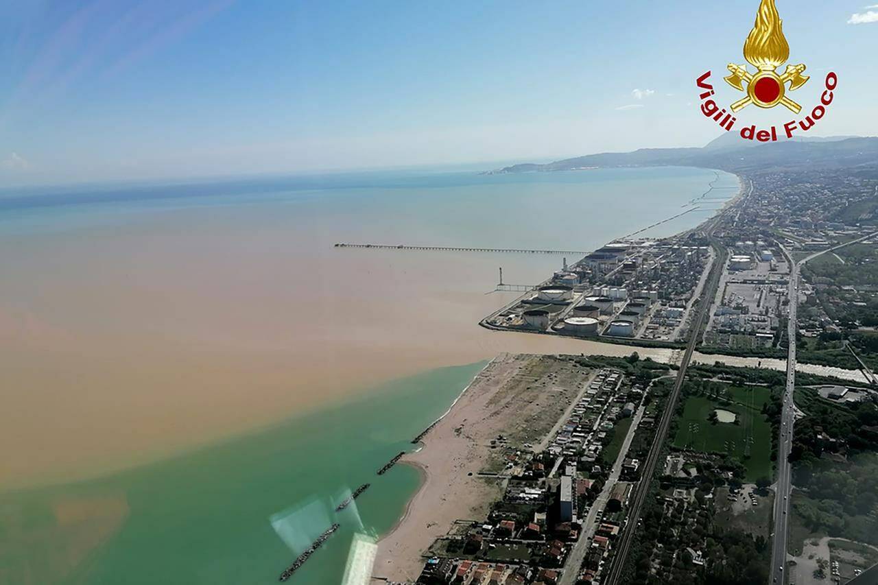 This picture released by the Italian firefighters shows an aerial view of the Senigallia coast after floods hit Marche region, central-east Italy, Friday, Sept. 16, 2022. Floodwaters triggered by heavy rainfall swept through several towns in the hilly region of Marche, central-east Italy early Friday, leaving 10 people dead and several missing, state radio said. Dozens of survivors scrambled onto rooftops or up trees to await rescue. (Italian Firefighters - Vigili del Fuoco via AP)