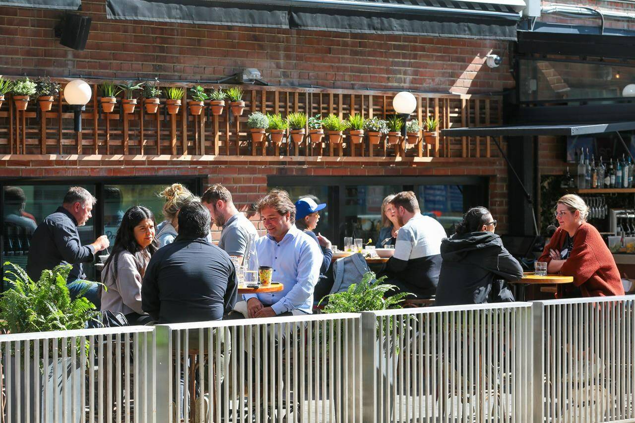 Patrons dine on a patio on King Street in Toronto, Tuesday, September 28, 2021. A new report says restaurants in Canada are ushering in higher prices, shorter menus, smaller portion sizes and reduced hours in a bid to survive inflation and labour shortages.THE CANADIAN PRESS/Evan Buhler