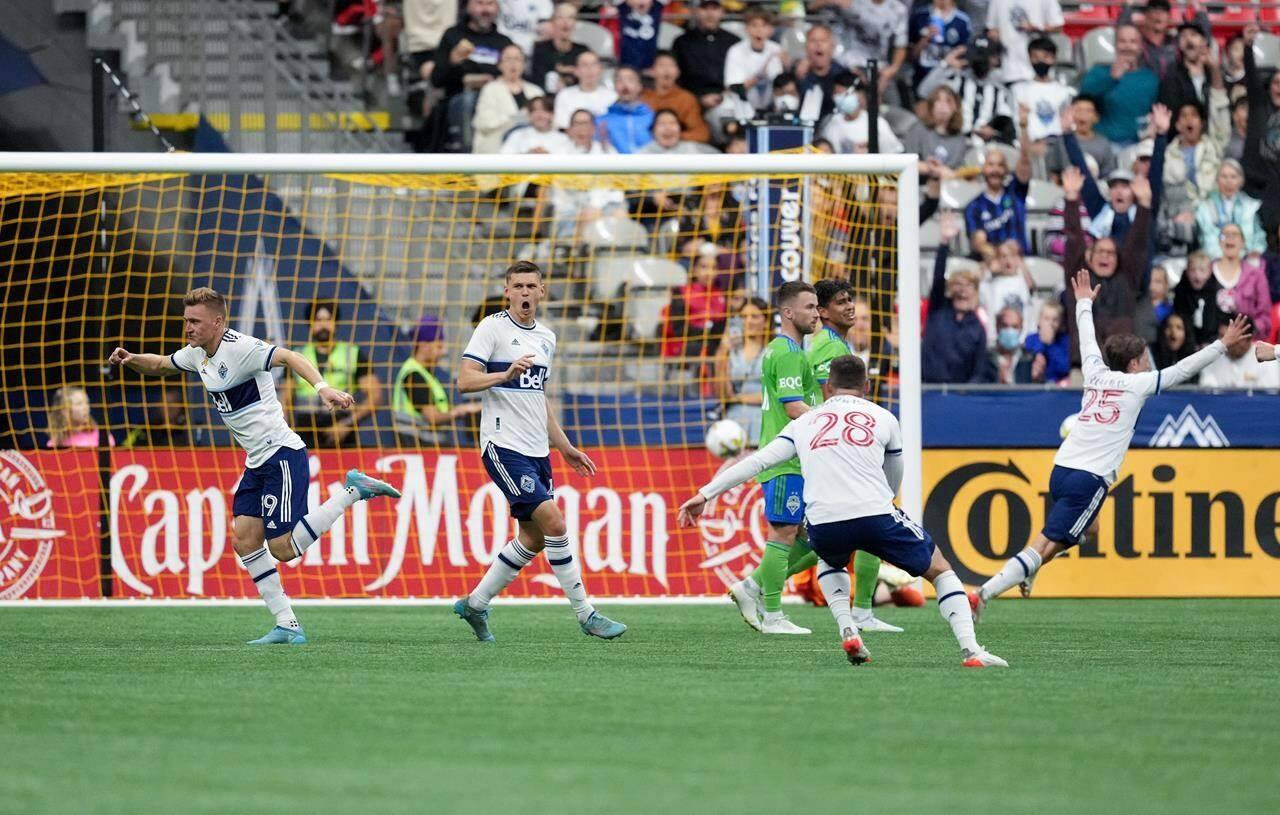 Vancouver Whitecaps’ Julian Gressel, from left to right, Ranko Veselinovic, Jake Nerwinski and Ryan Gauld celebrate Gressel’s goal against the Seattle Sounders during the first half of an MLS soccer game in Vancouver, on Saturday, September 17, 2022. THE CANADIAN PRESS/Darryl Dyck