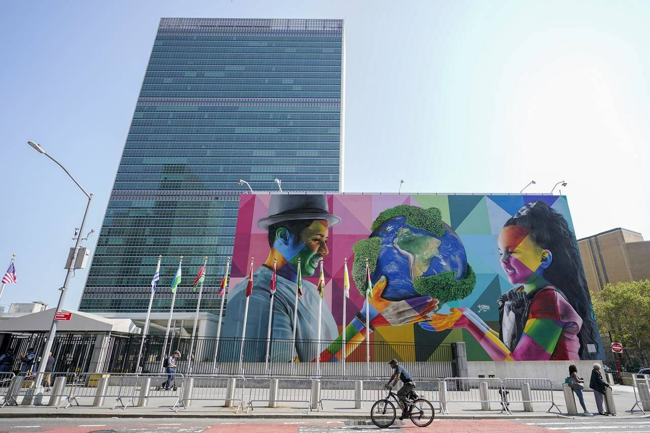 A mural by Brazilian artist Eduardo Kobra, focusing attention on climate change and stewardship of the planet is displayed outside the United Nations headquarters ahead of the General Assembly, Friday, Sept. 16, 2022. (AP Photo/Mary Altaffer)