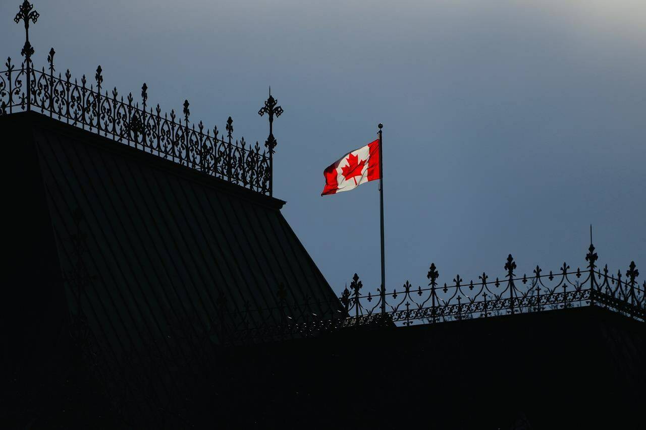 The Canada Flag flies on top of the East Block on Parliament Hill in Ottawa on Tuesday, Nov. 9, 2021. Rallies are planned in cities across Canada today to call on Ottawa to extend permanent status to undocumented migrants. THE CANADIAN PRESS/Sean Kilpatrick