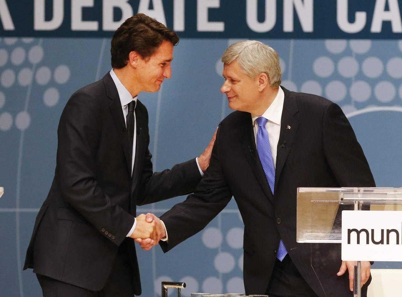 Then Conservative Leader Stephen Harper, right, and Liberal Leader Justin Trudeau shake hands following a debate in Toronto, on Monday, Sept. 28, 2015. ;Former PM Harper invested into Order of Canada while in London. THE CANADIAN PRESS/Mark Blinch
