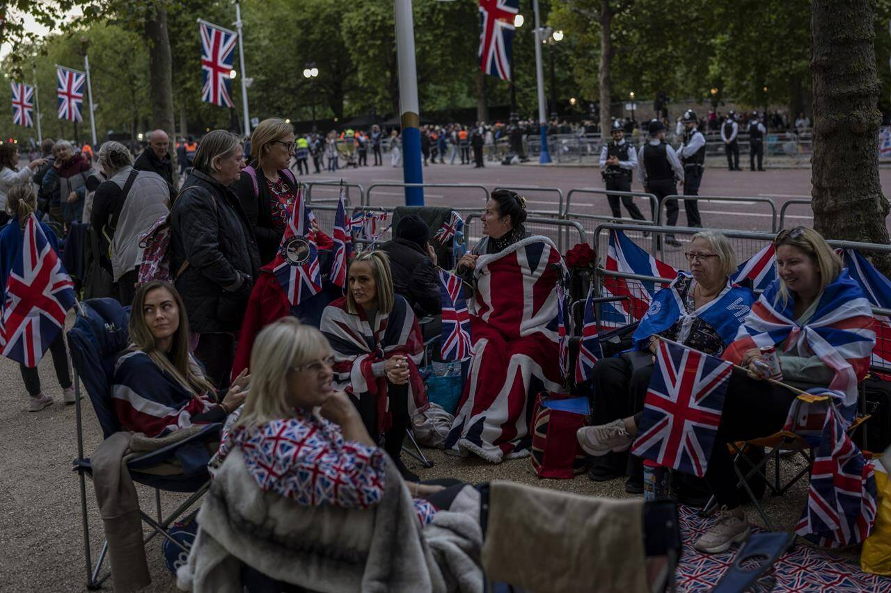 People camp out on The Mall on the eve of the funeral of Queen Elizabeth II in London, England, Sunday, Sept. 18, 2022. The funeral of Queen Elizabeth II, Britain’s longest-reigning monarch, takes place on Monday. (AP Photo/Bernat Armangue)