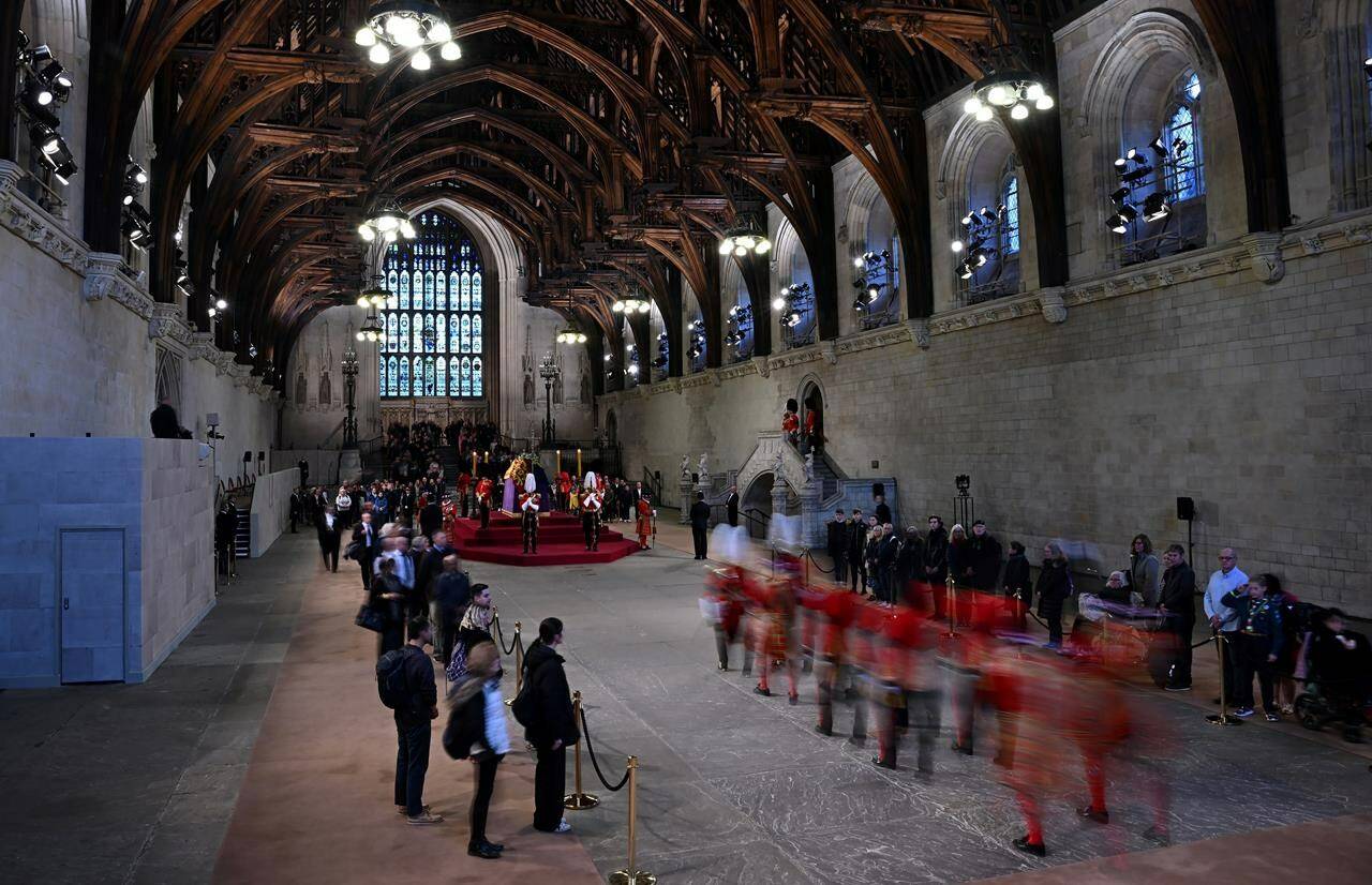 The King’s Body Guard, formed of Gentlemen at Arms, Yeomen of the Guard and Scots Guards, arrive to guard the coffin of Queen Elizabeth II, Lying in State inside Westminster Hall, at the Palace of Westminster in London, Sunday, Sept. 18, 2022. (Paul Ellis/Pool Photo via AP)