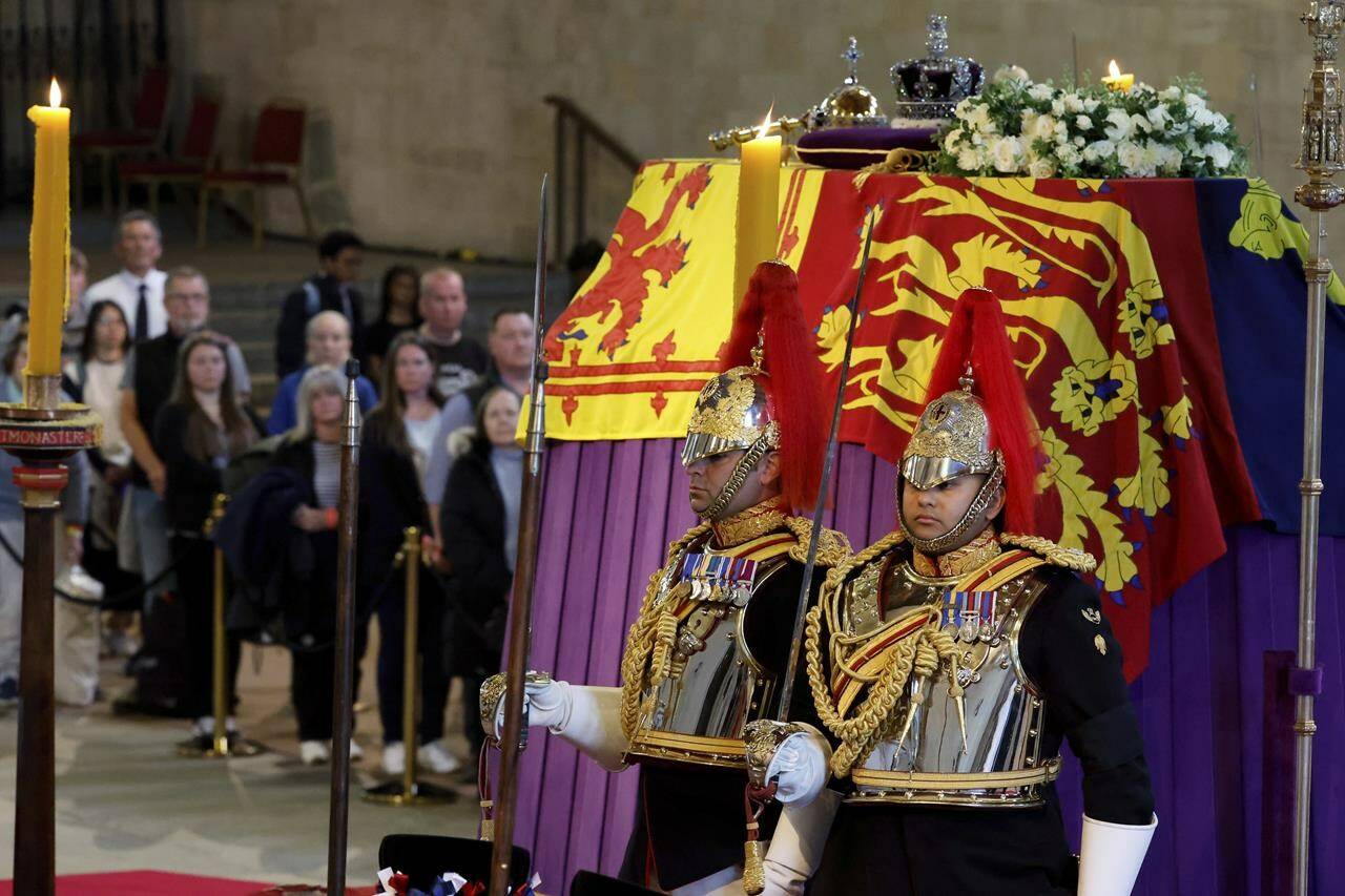 Household Cavalry, Blues and Royals stand guard around the coffin of Queen Elizabeth II during the lying in State inside Westminster Hall, at the Palace of Westminster in London, Sunday, Sept. 18, 2022. (Chip Somodevilla/Pool Photos via AP)