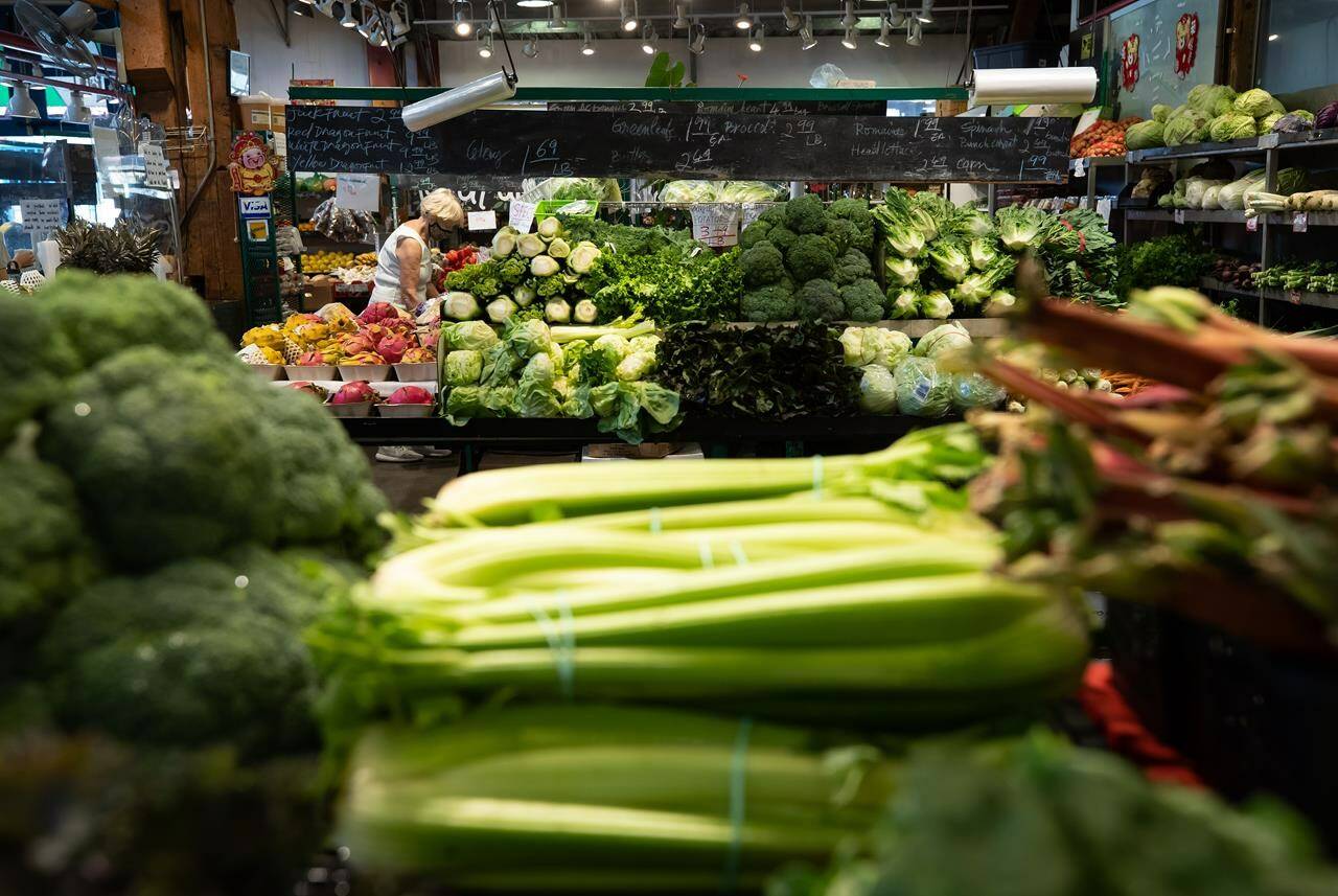 A woman shops for produce at the Granville Island Market in Vancouver, on Wednesday, July 20, 2022. Food inflation remains stubbornly high in Canada as grocery prices climbed at the fastest clip in more than four decades last month. THE CANADIAN PRESS/Darryl Dyck