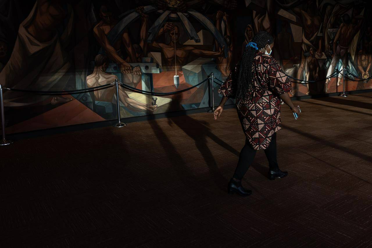 A person walks through the United Nations headquarters, Tuesday, Sept. 20, 2022, in New York. (AP Photo/Julia Nikhinson)