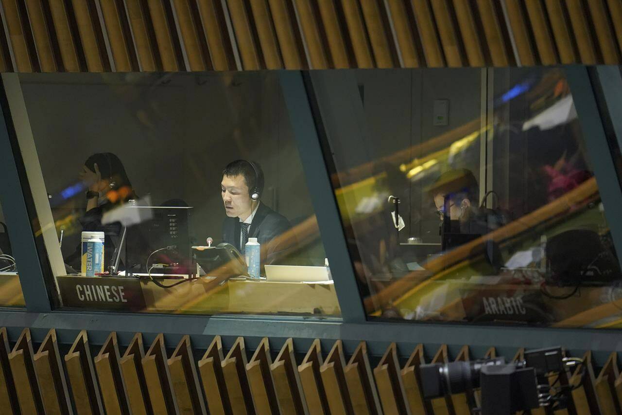 A Chinese translator works as a head of state addresses the 77th session of the General Assembly at United Nations headquarters, Tuesday, Sept. 20, 2022. (AP Photo/Mary Altaffer)