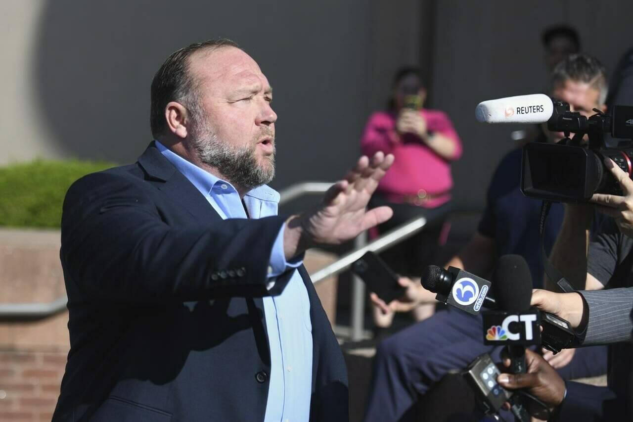 FILE - Alex Jones speaks to the media before entering court for day five of the Sandy Hook defamation damages trial at Connecticut Superior Court in Waterbury, Conn., Tuesday, Sept. 20, 2022. Seven days into his trial for calling the Sandy Hook school shooting a hoax, Jones is expected make his first courtroom appearance and begin testifying Thursday, Sept. 22 as he and his lawyer try to limit damages he must pay to families who lost loved ones in the massacre. (Tyler Sizemore/Hearst Connecticut Media via AP, File)