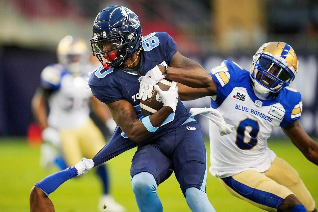 Toronto Argonauts' DaVaris Daniels (80) makes a reception as Winnipeg Blue Bombers' Les Maruo tries to defend during the first half of CFL football action in Toronto on July 4, 2022. The Blue Bombers and Argonauts can both secure home playoff games this weekend. THE CANADIAN PRESS/Mark Blinch