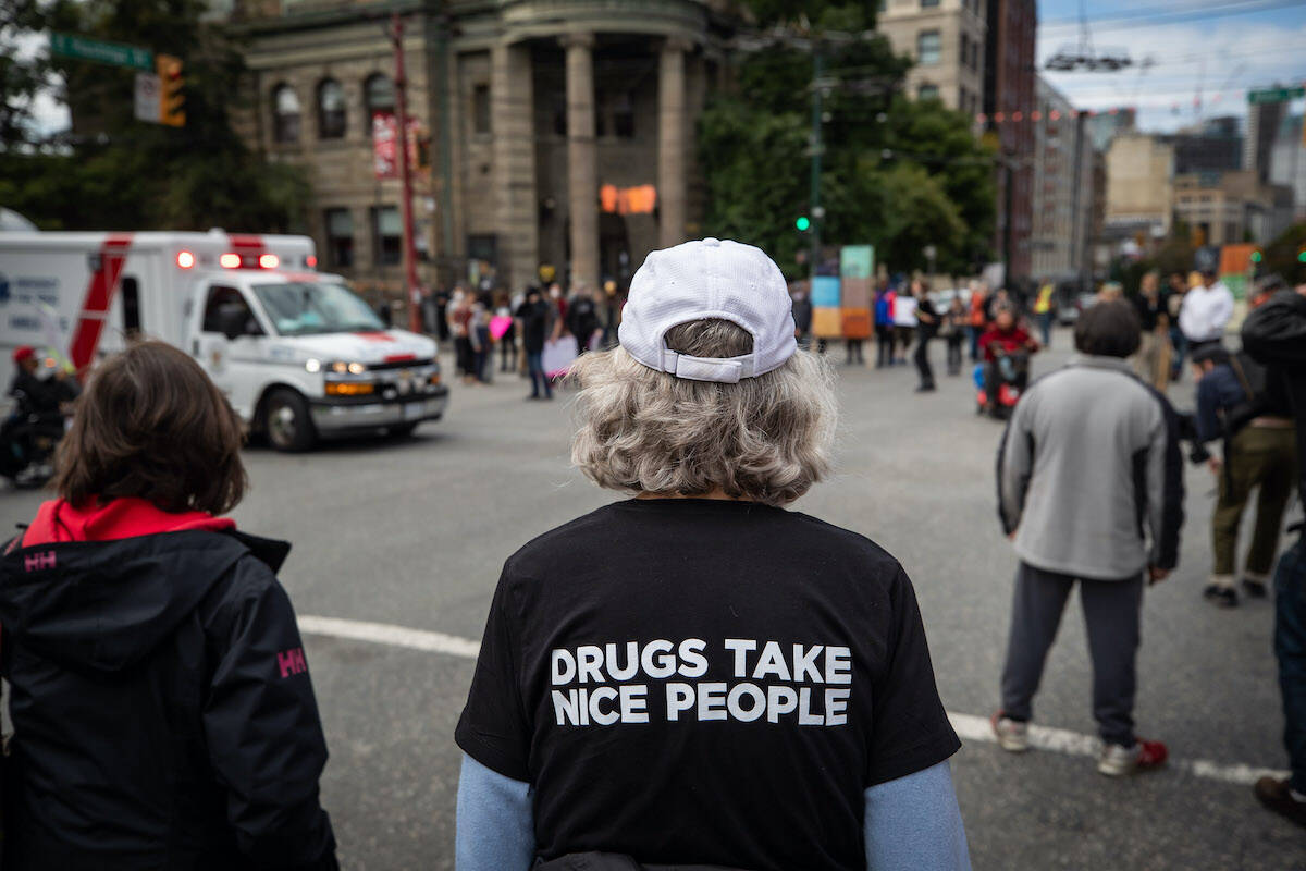 Paramedics respond to a call as Vancouver city councillor Jean Swanson attends a march on International Overdose Awareness Day, in Vancouver, on August 31, 2021. In August 2022, the BC Coroner Service says 169 British Columbians died to the toxic drug supply. THE CANADIAN PRESS/Darryl Dyck