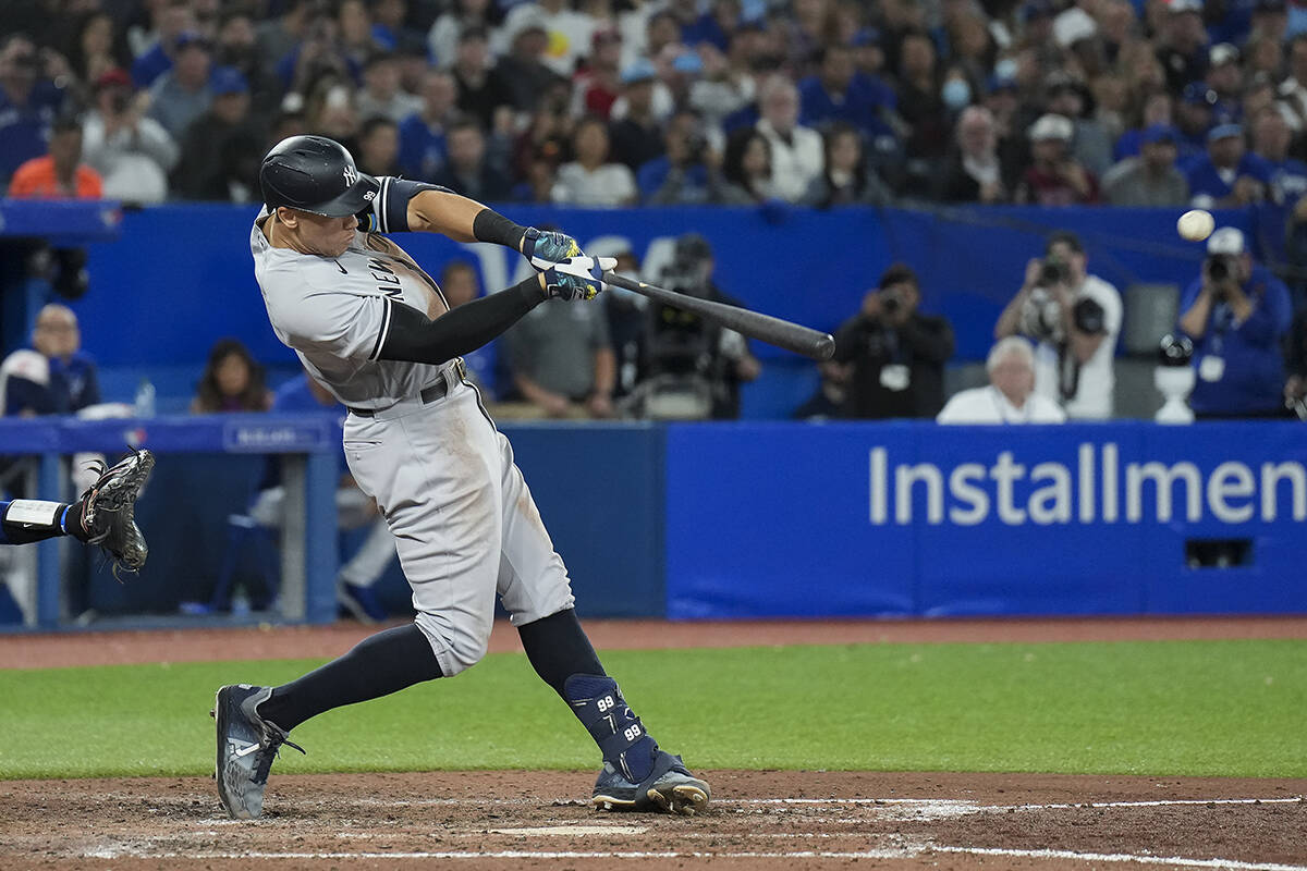 New York Yankees designated hitter Aaron Judge (99) hits his 61st home run of the season, a two-run shot, against the Toronto Blue Jays during seventh inning American League MLB baseball action in Toronto on Wednesday, September 28, 2022. THE CANADIAN PRESS/Nathan Denette