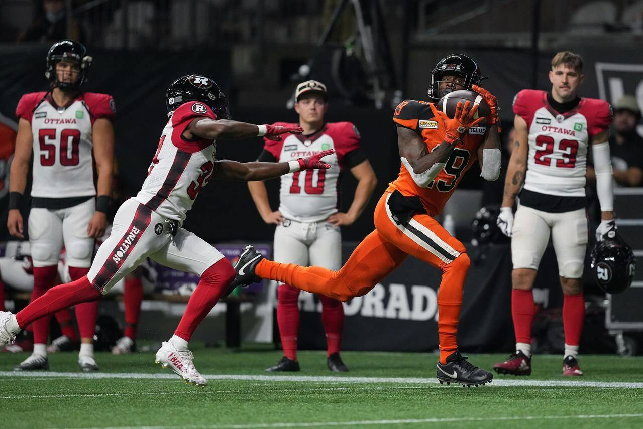 B.C. Lions’ Dominique Rhymes, right, makes the reception as Ottawa Redblacks’ Brandin Dandridge defends during the first half of CFL football game in Vancouver, on Friday, September 30, 2022. THE CANADIAN PRESS/Darryl Dyck