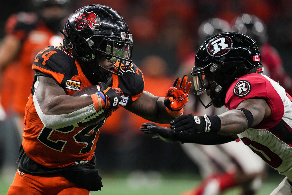 B.C. Lions’ James Butler, left, tries to fend off Ottawa Redblacks’ Alonzo Addae as he carries the ball during the second half of a CFL football game in Vancouver, on Friday, September 30, 2022. THE CANADIAN PRESS/Darryl Dyck