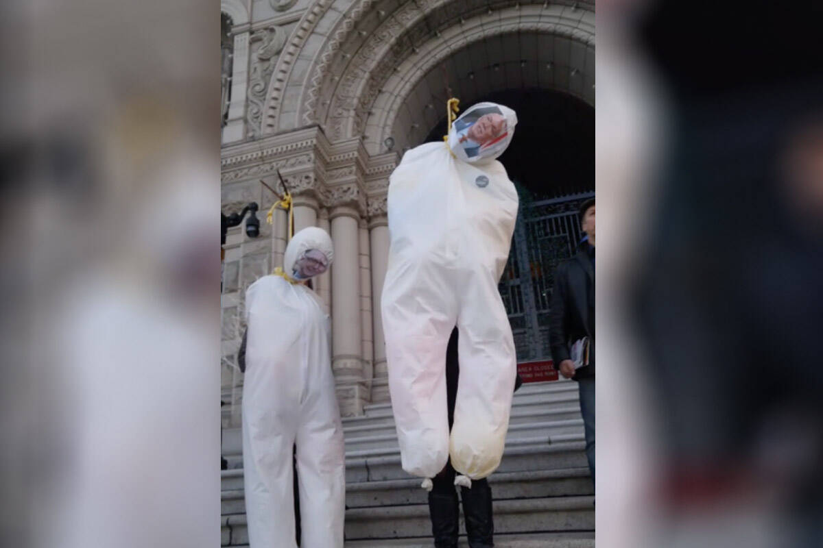The faces of Premier John Horgan and Health Minister Adrian Dix on effigies being hung by the neck during an anti-vaccine event at the B.C. legislature on Dec. 9, 2021. (Photo courtesy of Facebook/Anne O’Neil)
