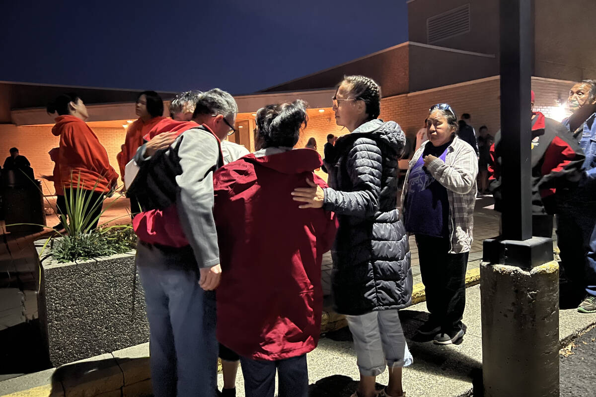 Casey Myers, the father of Surrance Myers, receives support from community members during a candlelight vigil outside the Williams Lake RCMP detachment Sunday evening (Oct. 2). Casey said he was notified Saturday evening that his son died in police cells. (Angie Mindus photo - Williams Lake Tribune)