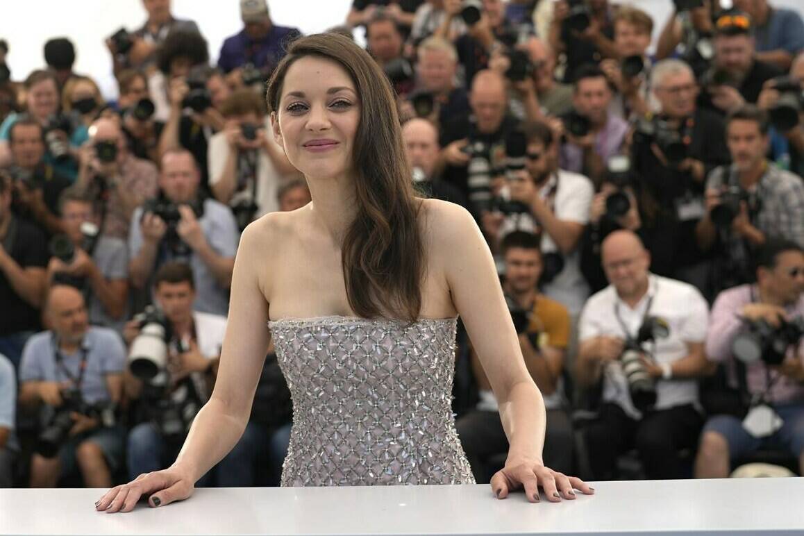FILE - Marion Cotillard poses for photographers at the photo call for the film ‘Brother and Sister’ at the 75th international film festival, Cannes, southern France, Saturday, May 21, 2022. Oscar-winning actresses Marion Cotillard and Juliette Binoche, as well as other French stars of screen and music, filmed themselves chopping off locks of their hair in a video posted Wednesday Oct.5, 2022 in support of protesters in Iran. (AP Photo/Petros Giannakouris, File)