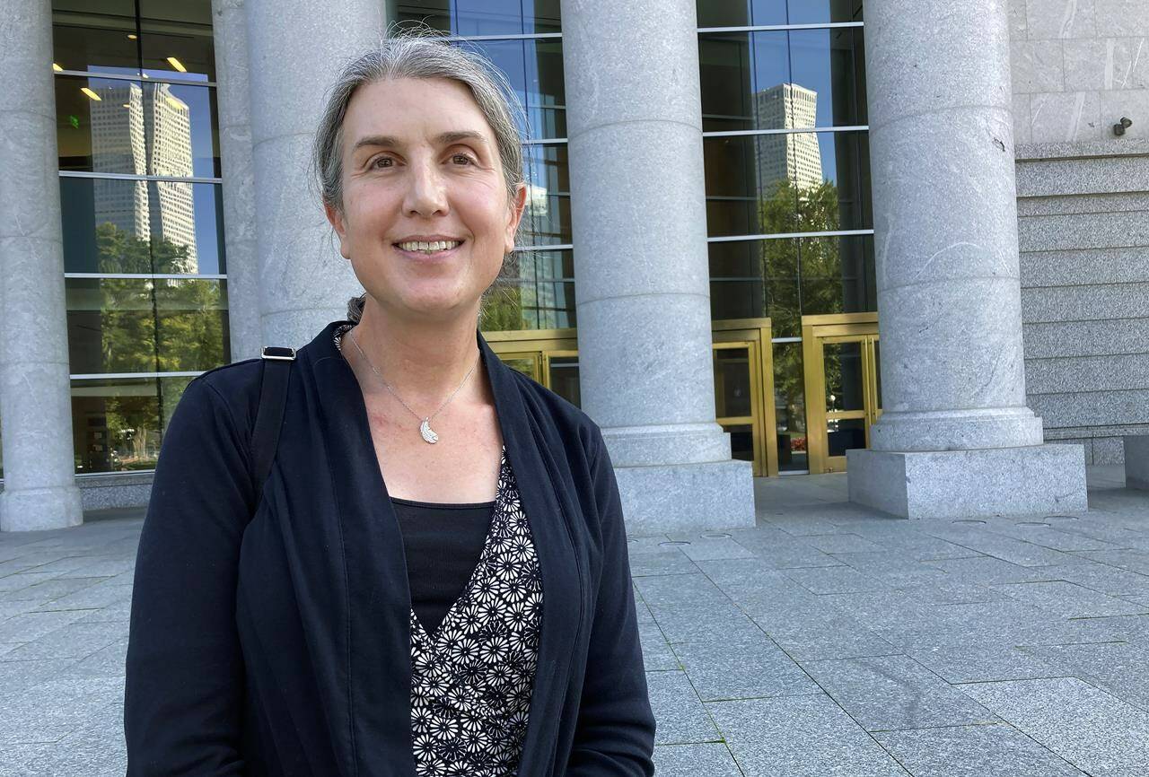 Colorado lawyer Autumn Scardina poses for photos outside the Ralph Carr Colorado Judicial Center in Denver, Wednesday, Oct. 5, 2022. Scardina, who is transgender, sued Colorado baker Jack Phillips after he refused to make her a cake intended to celebrate her gender transition. (AP Photo/Colleen Slevin)