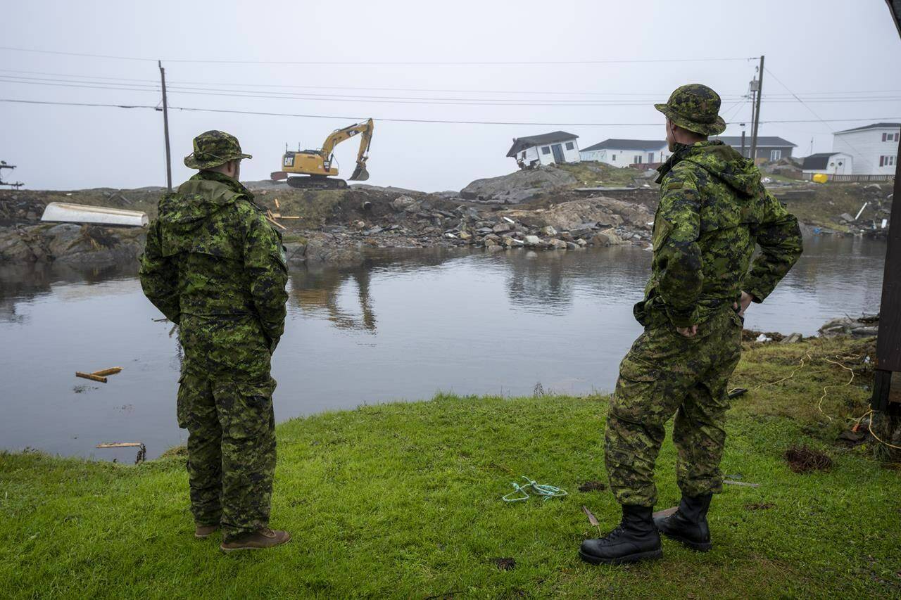 Canadian Armed Forces members from St John’s survey the devastation left by post-tropical storm Fiona in Burnt Island, N.L., on Wednesday, September 28, 2022.THE CANADIAN PRESS/Frank Gunn