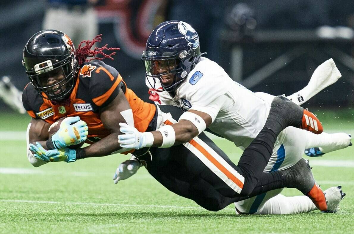 BC Lions’ Lucky Whitehead (left) catches a pass and gets tackled by Toronto Argonauts’ DaShaun Amos during second half of CFL football action in Vancouver on June 25, 2022. Toronto (8-6) hosts B.C. (10-4) on Friday night at BMO Field. THE CANADIAN PRESS/Rich Lam